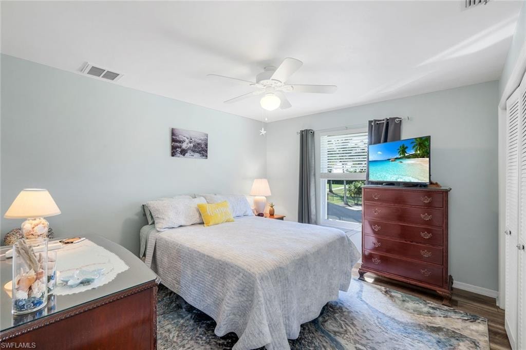 Bedroom with a closet, ceiling fan, and wood finished floors