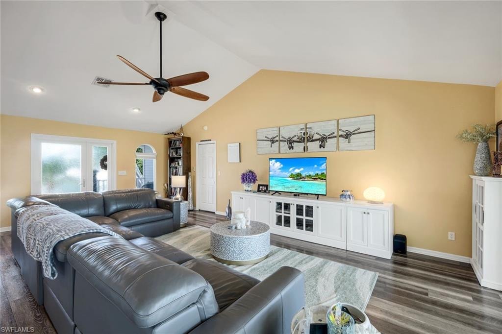 Living room with high vaulted ceiling, dark wood-style floors, a ceiling fan, and recessed lighting