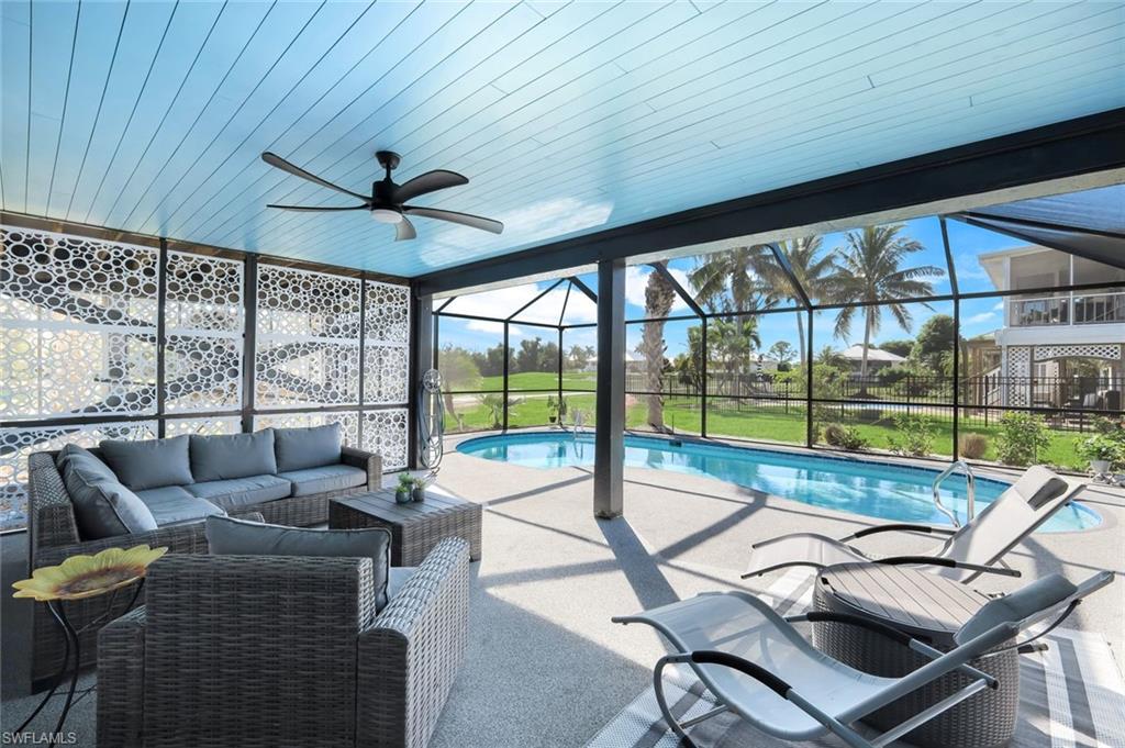 Swimming pool with a sunroom, a lanai, a patio, ceiling fan, and outdoor lounge area