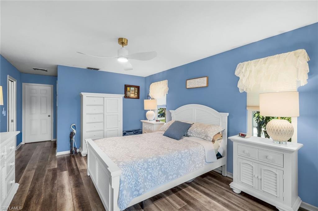 Bedroom with dark wood-type flooring and ceiling fan
