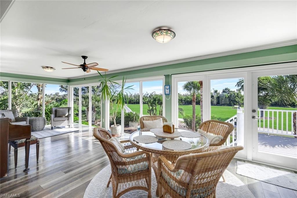 Sunroom / solarium featuring wood finished floors