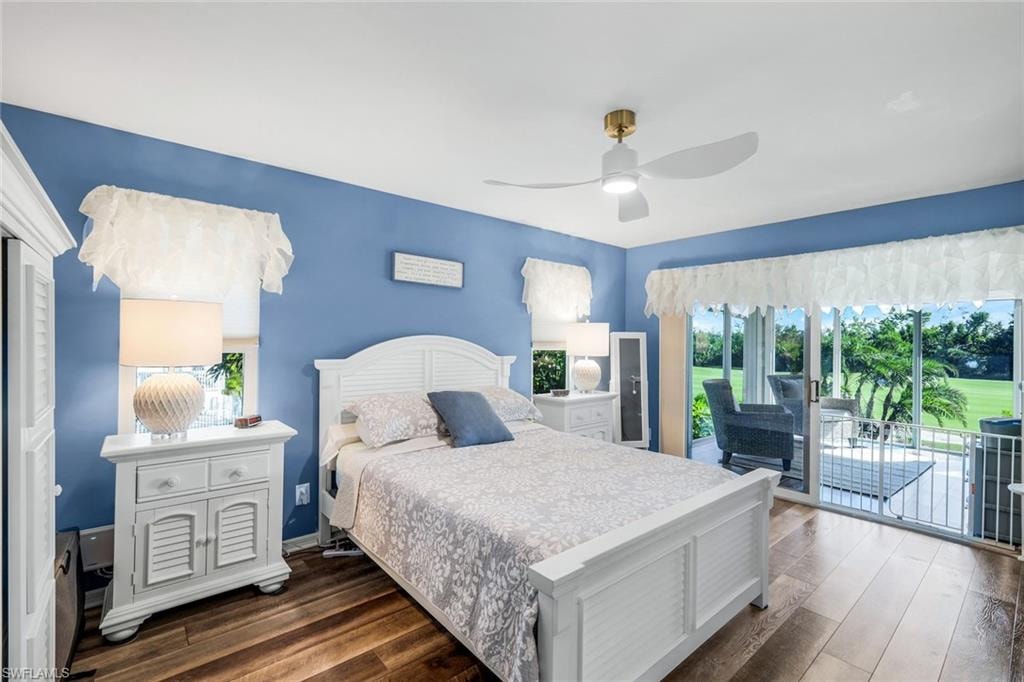 Bedroom featuring access to outside, dark wood-style floors, and a ceiling fan