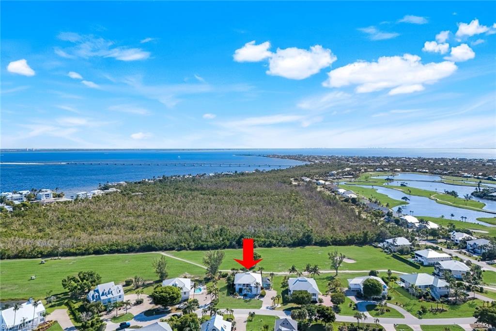 Aerial perspective of suburban area featuring a nearby body of water