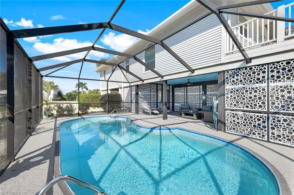 Outdoor pool with a patio, a lanai, ceiling fan, and a sunroom