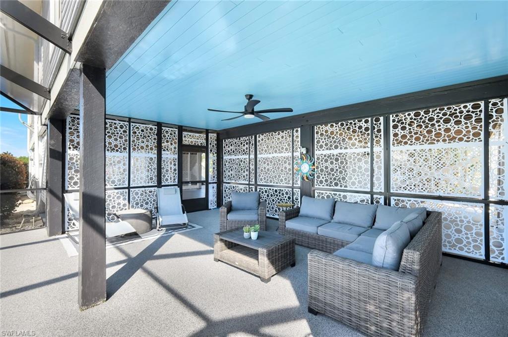 Sunroom / solarium with ceiling fan, healthy amount of natural light, and a patio