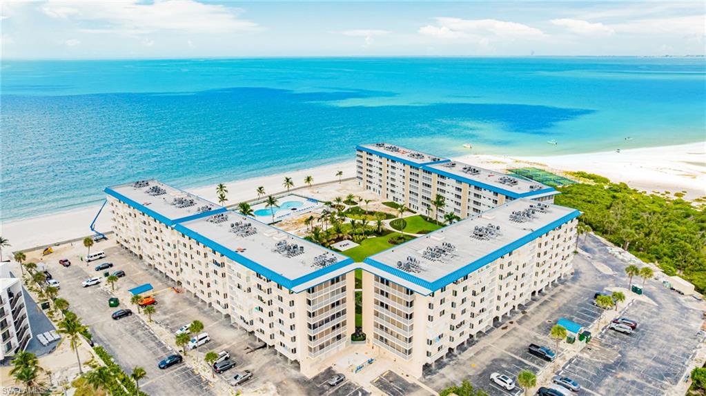 Aerial view of expansive coastline and apartment complex / building