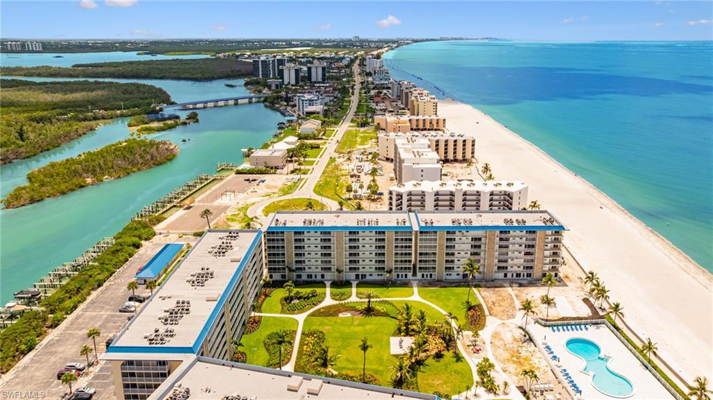 View of urban area with apartment complex / building and waterfront with a beach