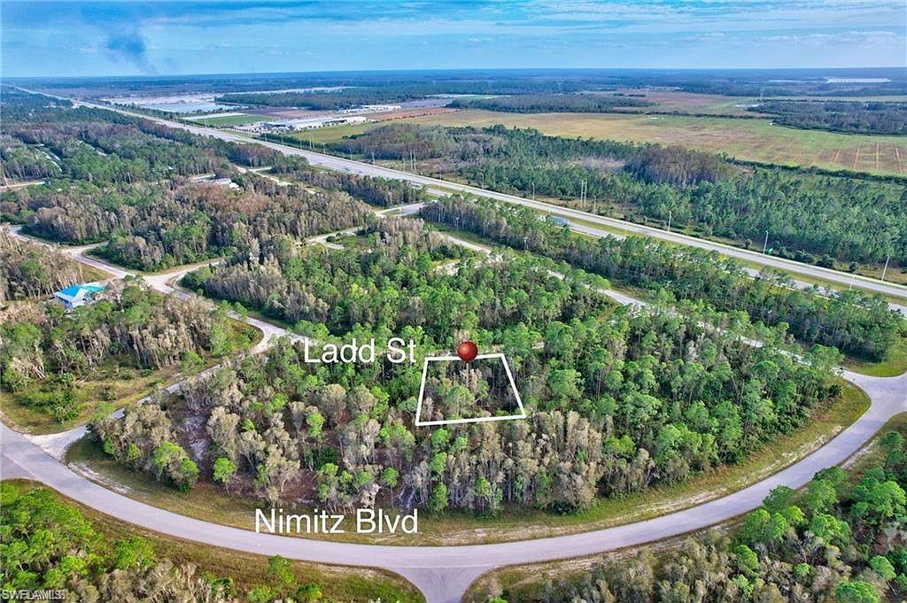 Aerial view of property's location featuring a forest and property boundaries highlighted