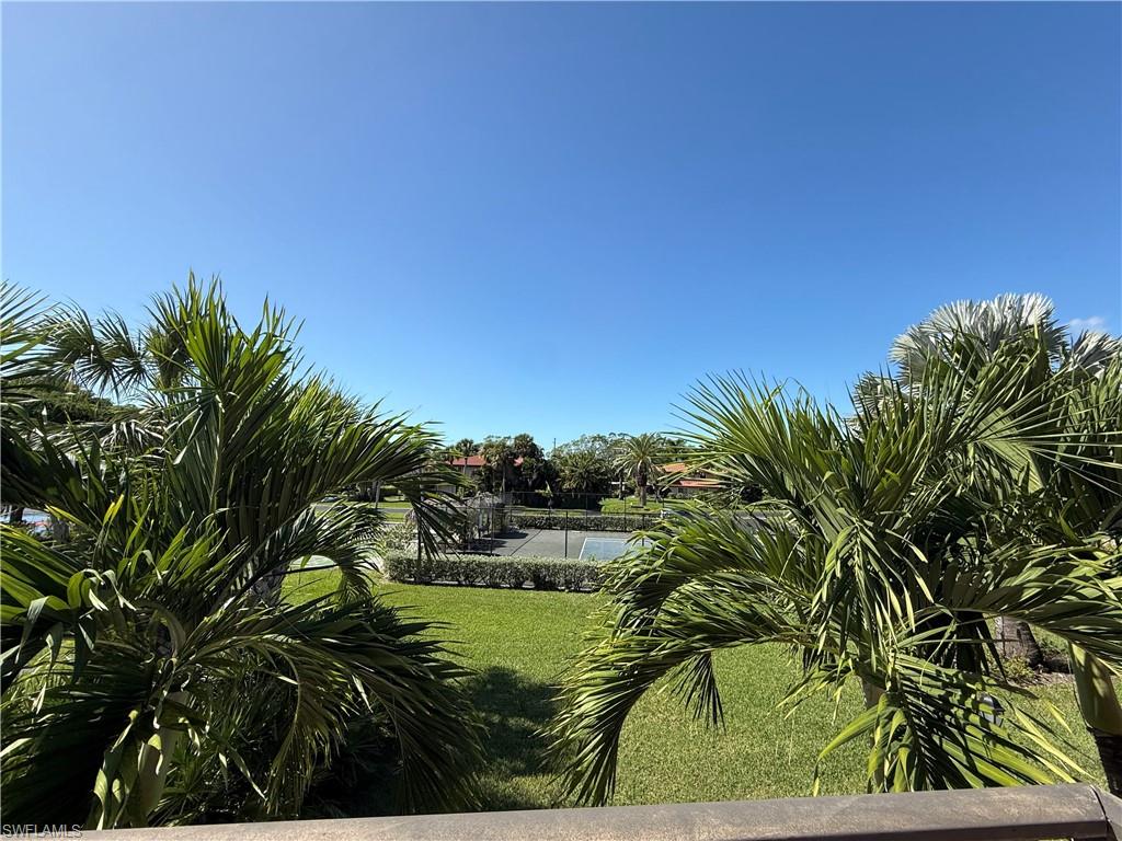 View of home's community with a lawn and a swimming pool