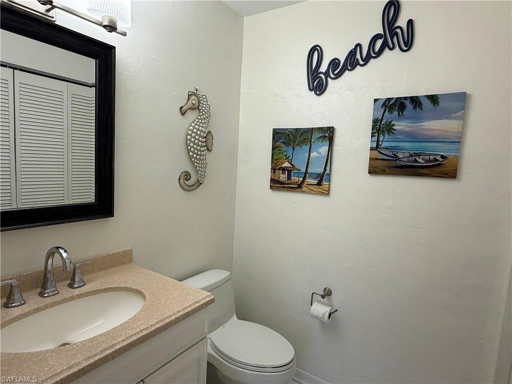 1/2 Bathroom with vanity and toilet