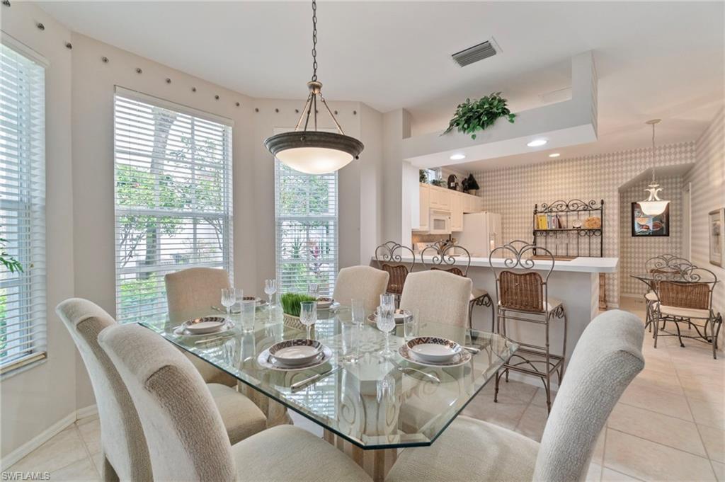 Dining area featuring light tile patterned floors, plenty of natural light, recessed lighting, and wallpapered walls