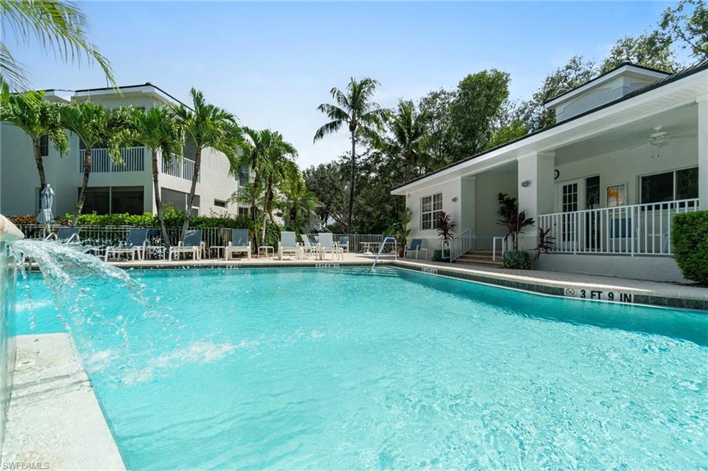 Community pool with ceiling fan, a patio area, and a porch