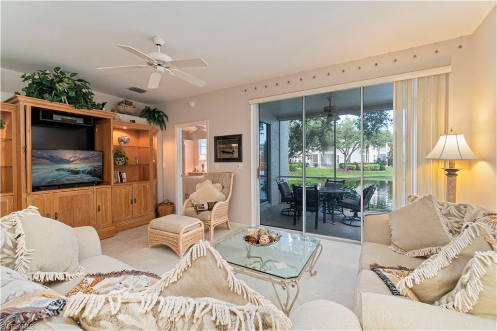 Living area with a ceiling fan and a sunroom