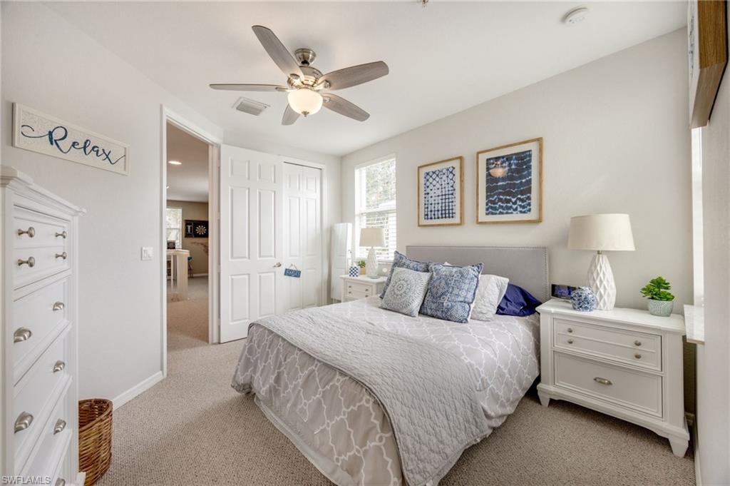 Bedroom featuring light carpet, a closet, and ceiling fan