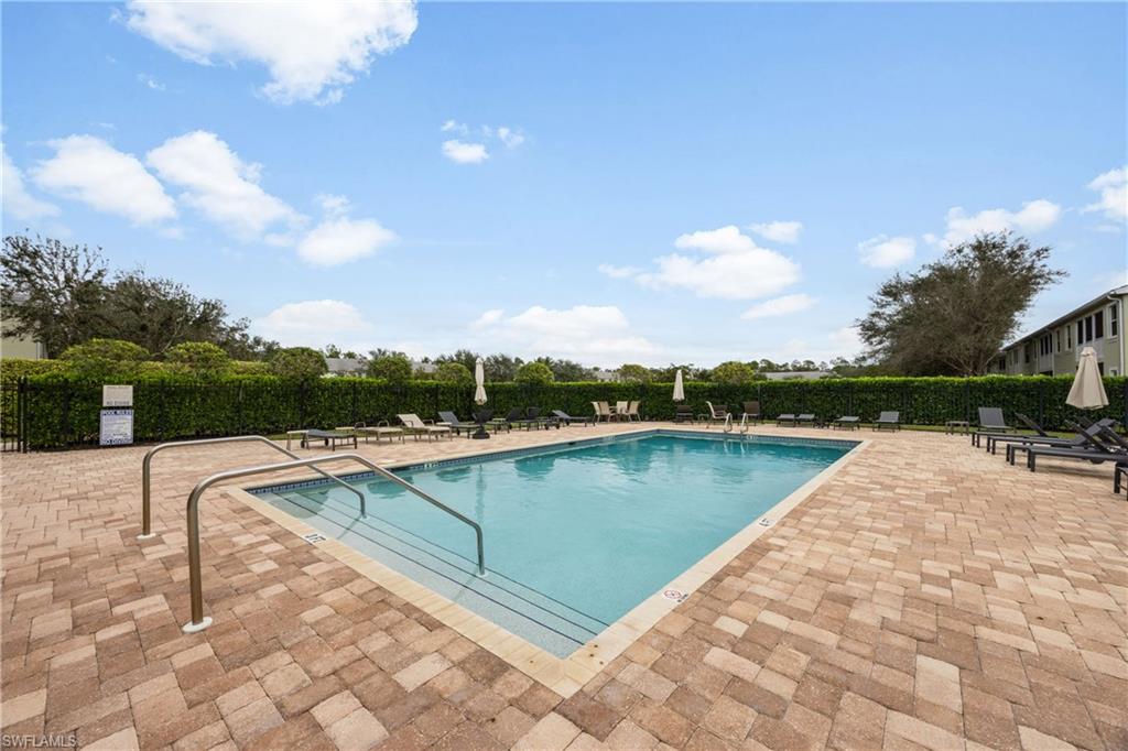 Community pool with a patio