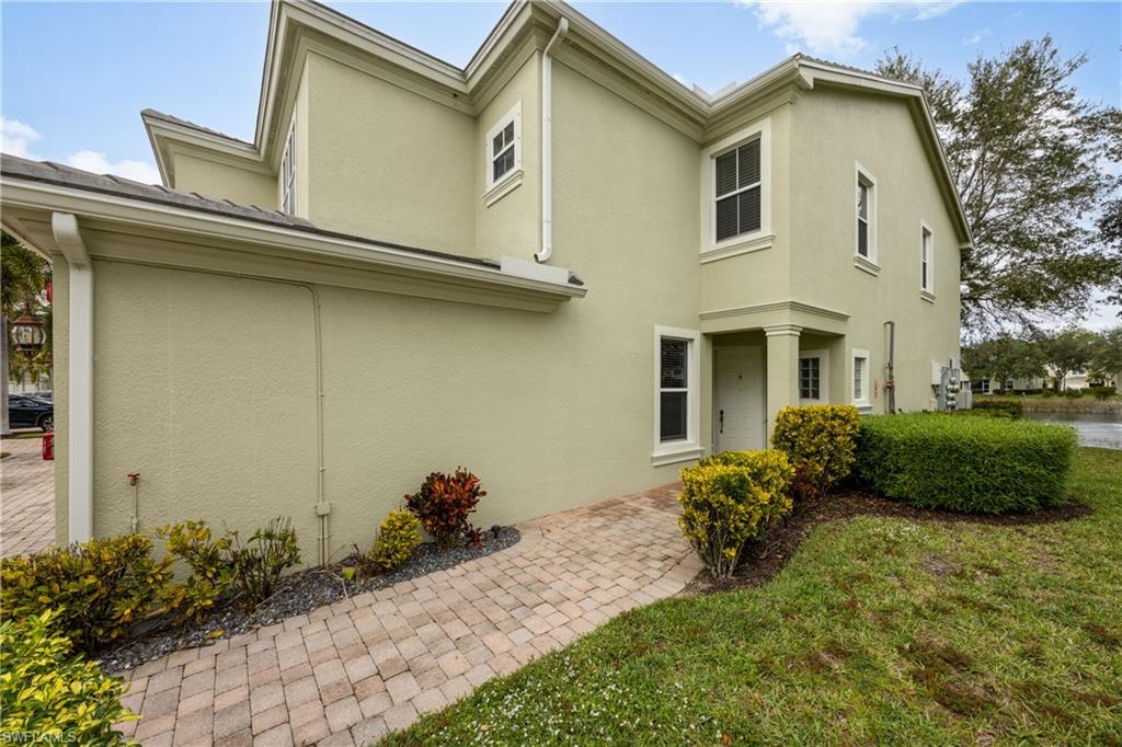 View of side of property with stucco siding and a yard