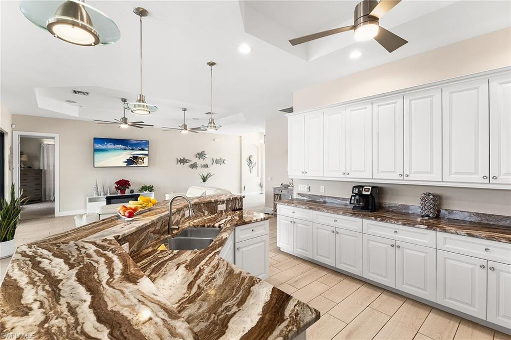 Kitchen with white cabinetry and granite countertops