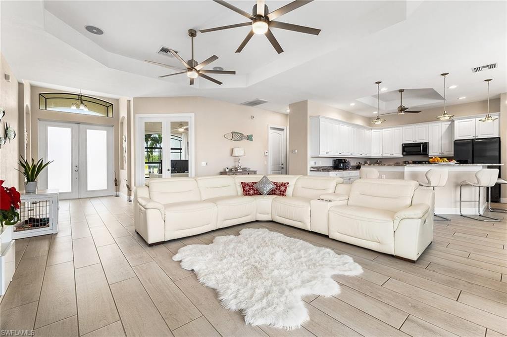 Living room with plentiful natural light and tray ceiling