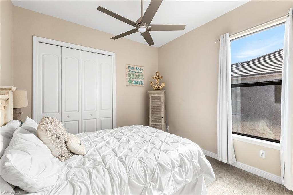 Bedroom 2 with carpet flooring, ceiling fan, and a closet