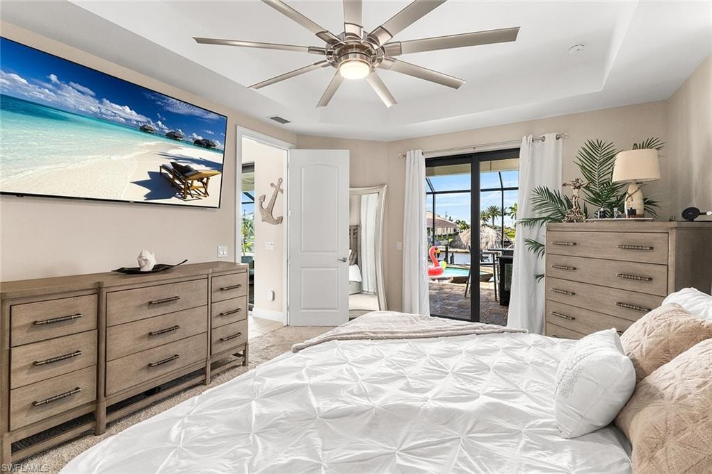 Owners suite featuring access to outside and ceiling fan