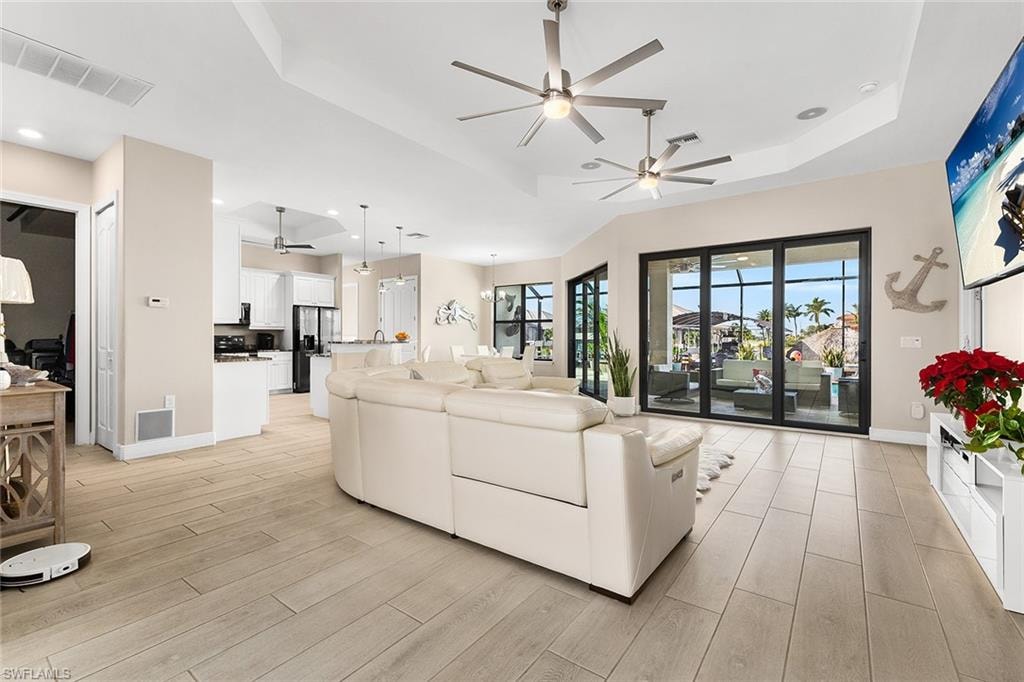 Living room with plentiful natural light and tray ceiling