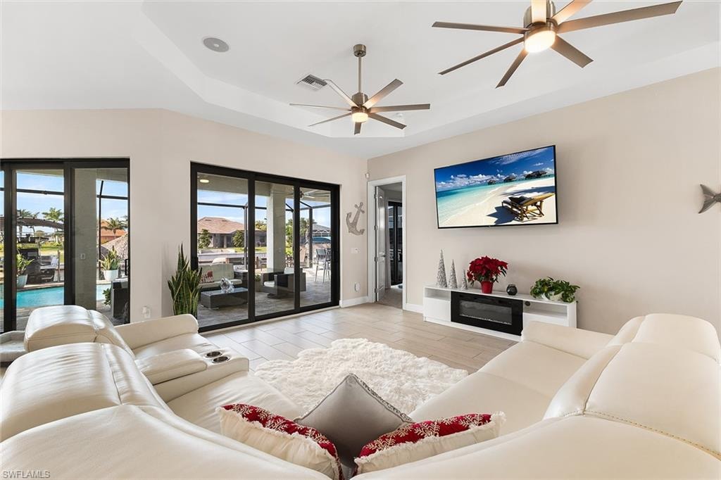 Living room with plentiful natural light and tray ceiling