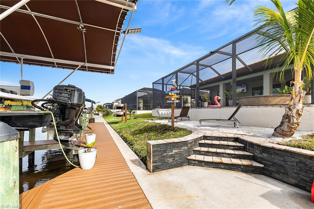 View of composite dock with 3 boat lifts, custom private beach and kayak rack