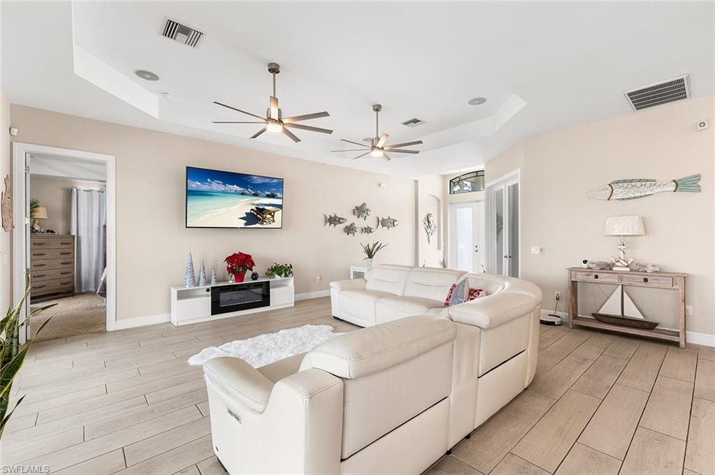 Living room with plentiful natural light and tray ceiling