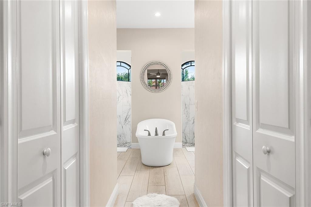 Owners bathroom featuring and shower with separate bathtub