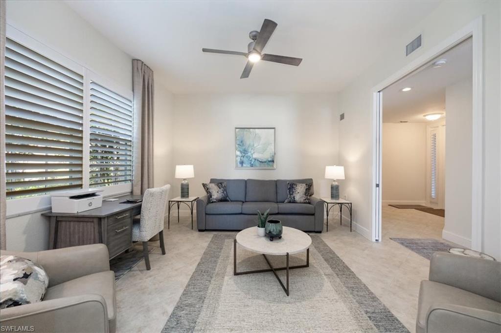Living room featuring a ceiling fan, recessed lighting, and light colored carpet