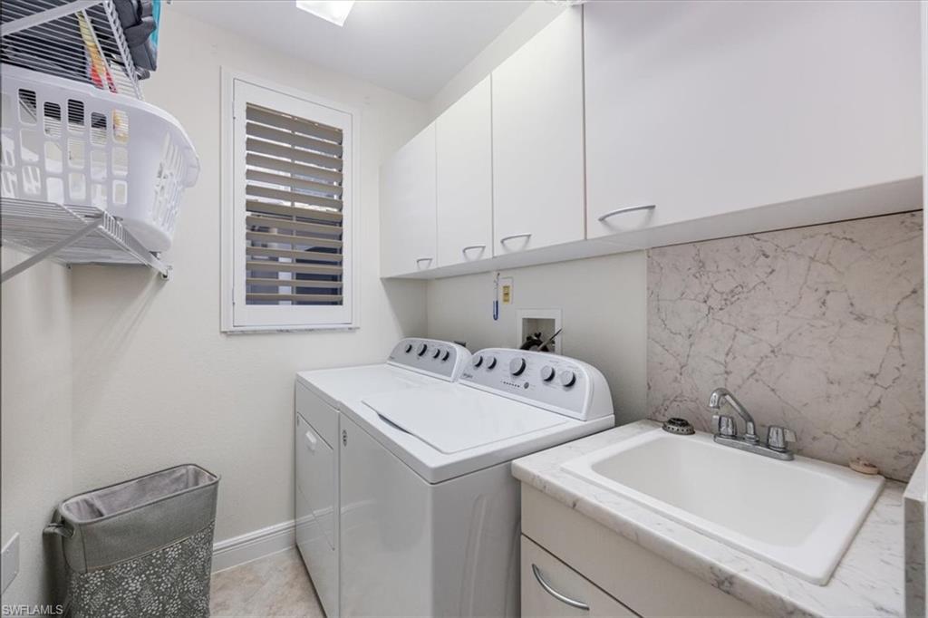 Washroom featuring cabinet space and washer and dryer