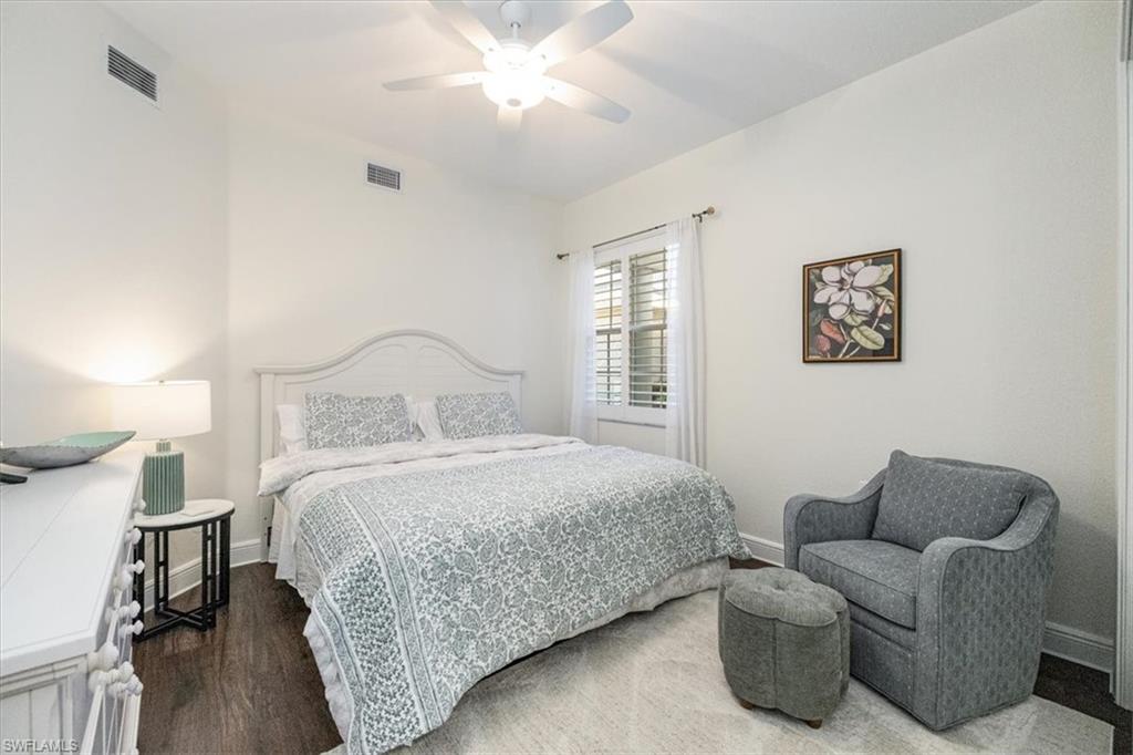 Bedroom featuring dark wood-style floors and ceiling fan