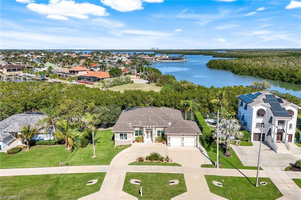 Aerial view of residential area featuring a large body of water