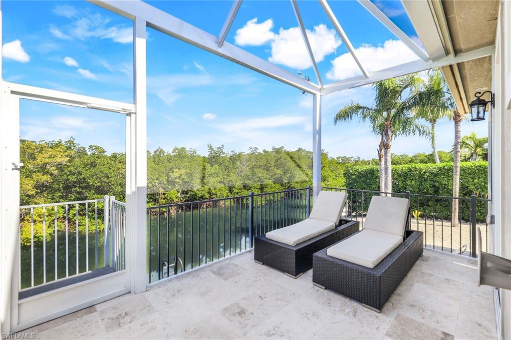 Sunroom / solarium with view of wooded area