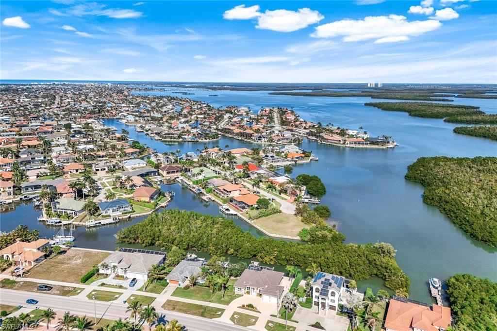 Aerial perspective of suburban area with a large body of water