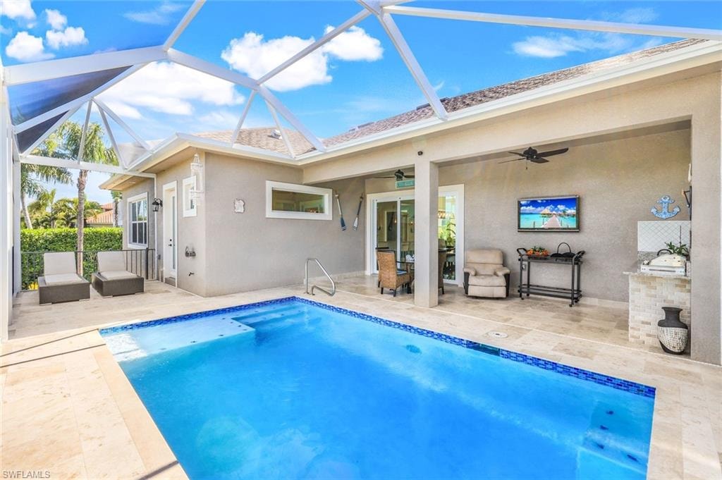 Swimming pool with a sunroom, a patio area, a ceiling fan, a lanai, and an outdoor living space