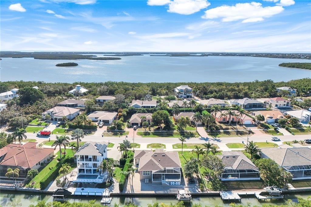 Aerial view of residential area featuring a nearby body of water