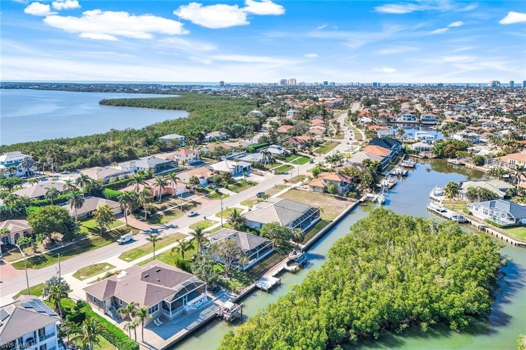 Aerial view of residential area featuring a nearby body of water