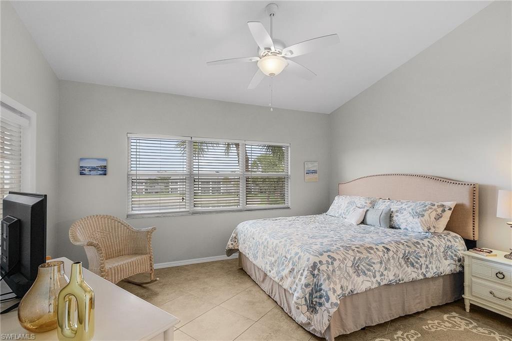 Bedroom with light tile patterned flooring and ceiling fan