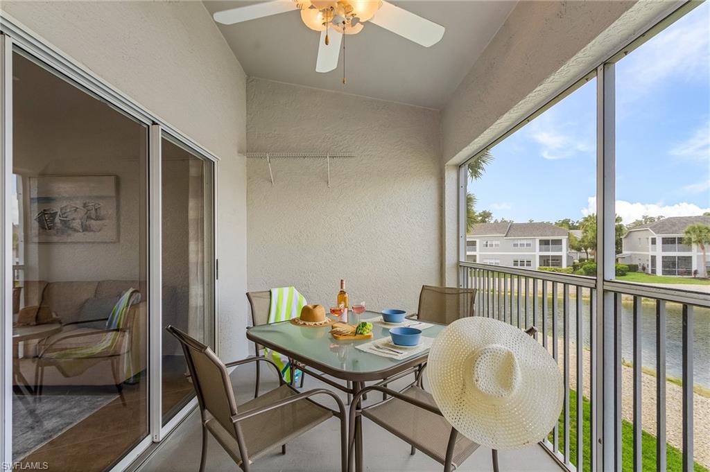 Balcony with a water view and ceiling fan