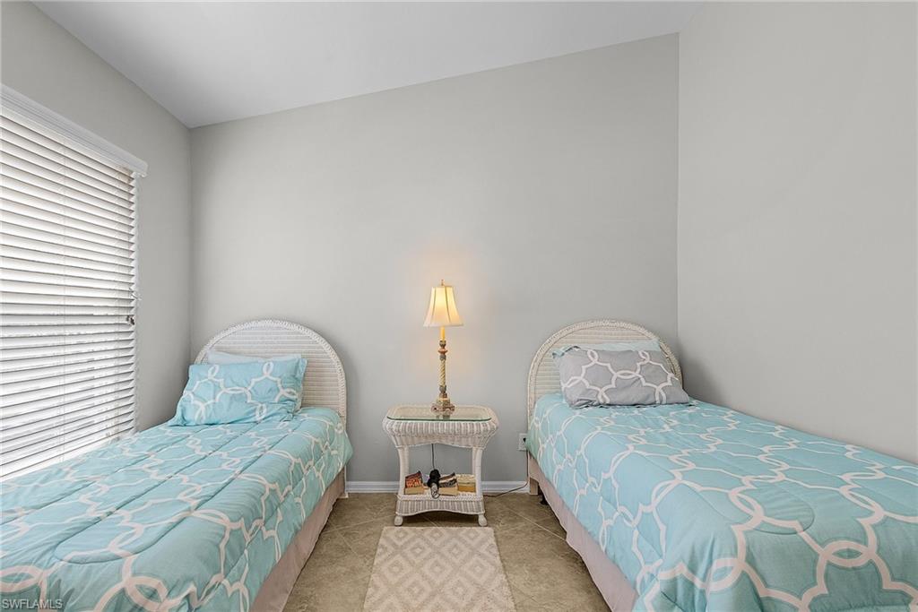 Bedroom with baseboards and tile patterned flooring