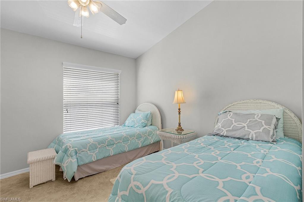 Bedroom with a ceiling fan and baseboards
