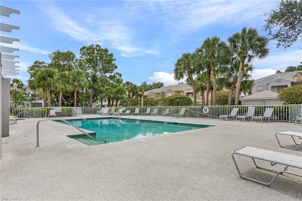 Community pool featuring a patio area and a residential view