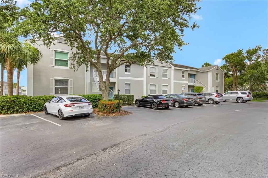 View of property featuring uncovered parking