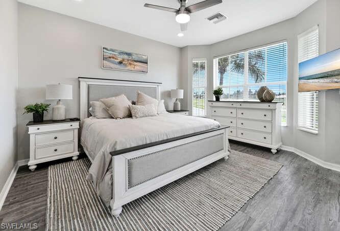 Bedroom featuring dark wood-type flooring, a ceiling fan, and recessed lighting