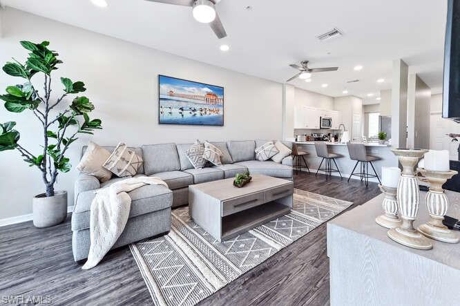 Living area featuring dark wood-style floors, recessed lighting, and a ceiling fan