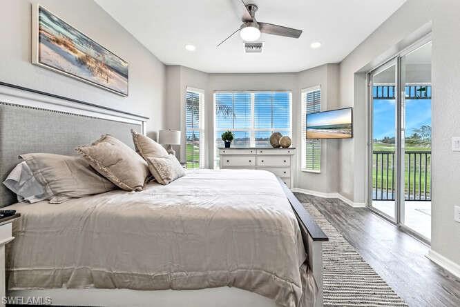 Bedroom featuring wood finished floors, access to exterior, multiple windows, a ceiling fan, and recessed lighting