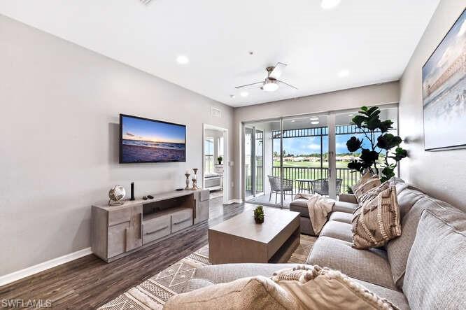 Living area with wood finished floors, a ceiling fan, and recessed lighting