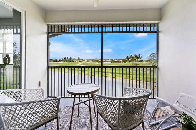 Sunroom / solarium featuring view of golf course