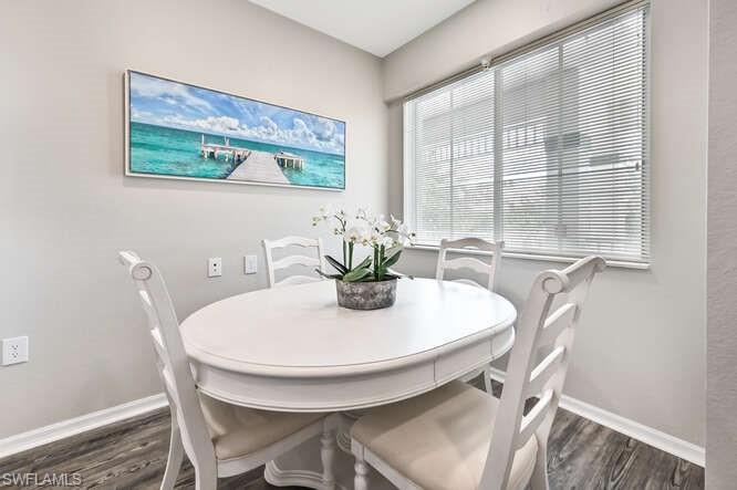 Dining room with baseboards and dark wood finished floors